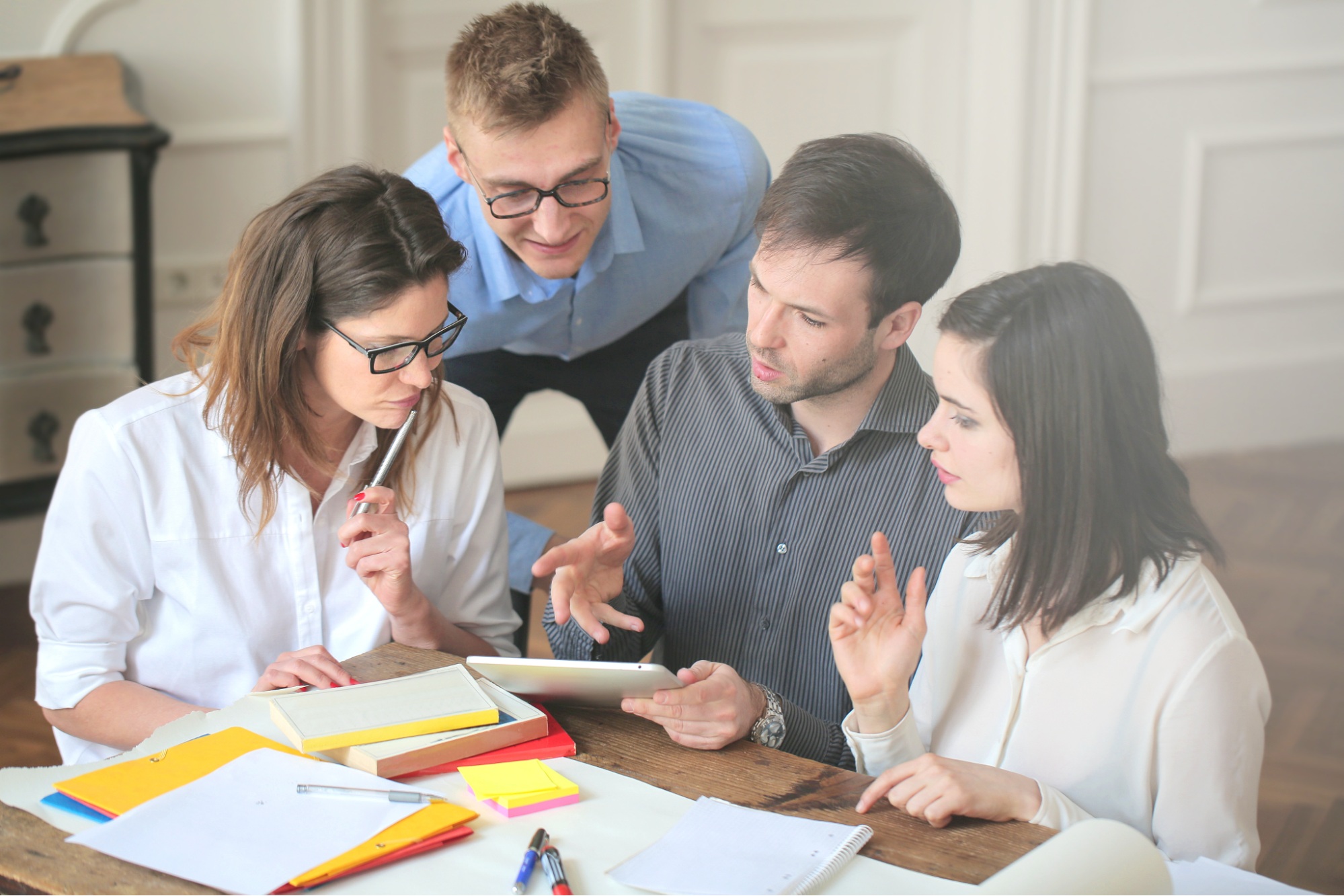 Business professionals reviewing plans during a leadership discussion.