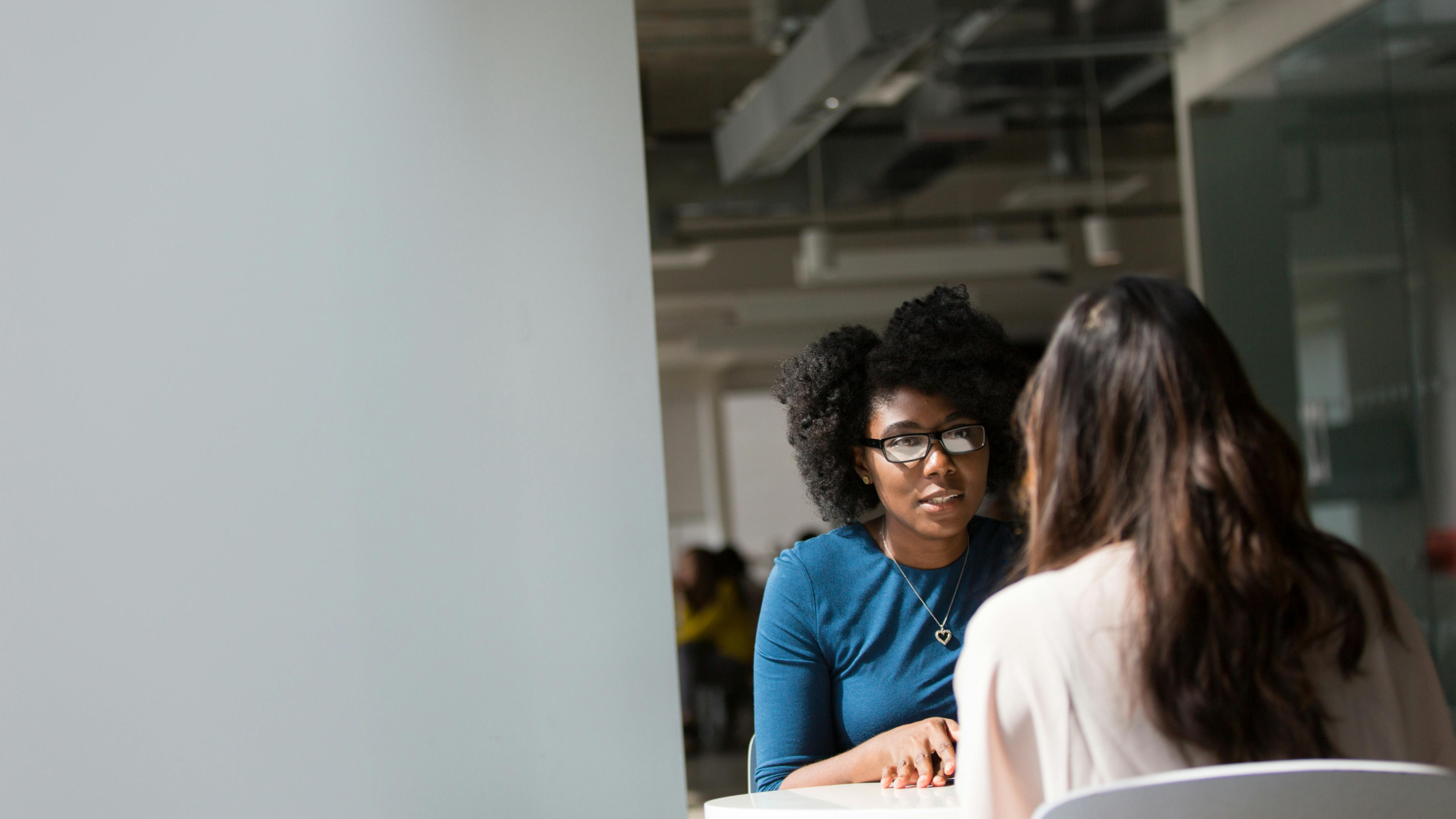 Two women discussing interview questions and answers during a formal job interview